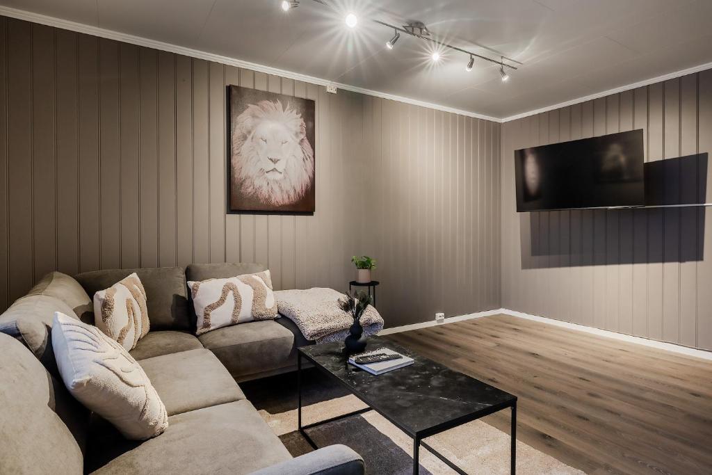 a living room with a couch and a table at Fauske Central Apartment - Cozy & Walkable in Fauske