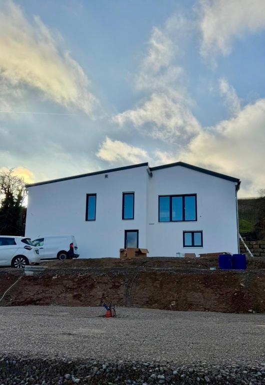 a large white house on the side of a road at Tiny Stay Guesthouse - Würzburg in Würzburg