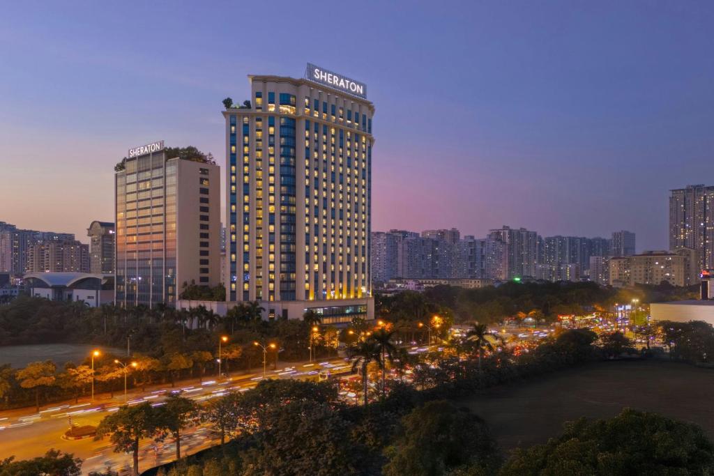 a city skyline with tall buildings at night at Sheraton Hanoi West in Hanoi