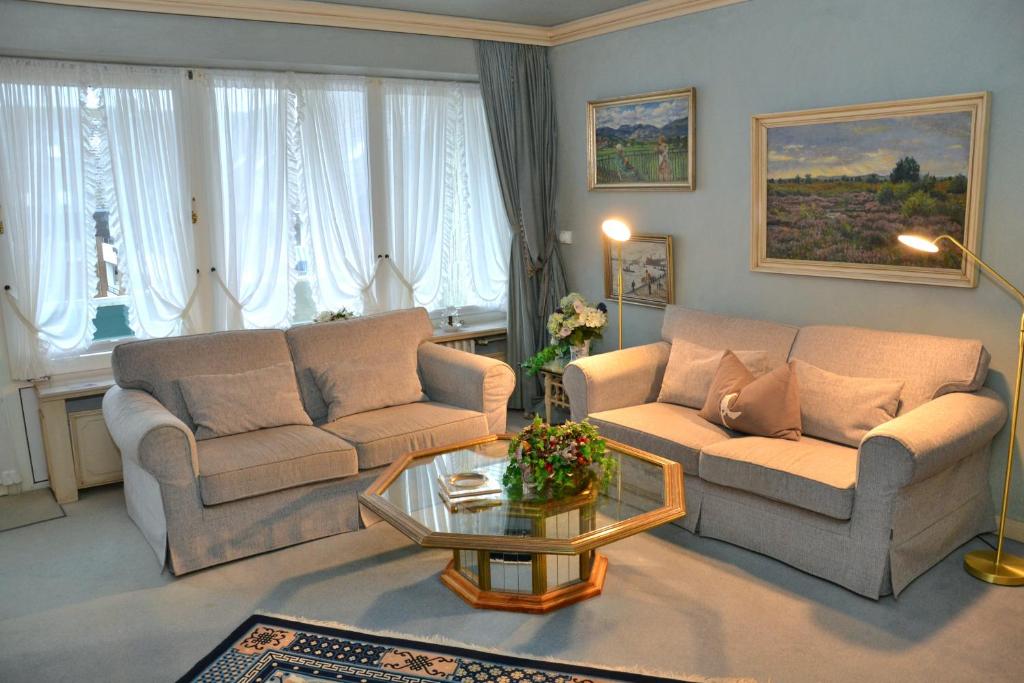 a living room with two couches and a coffee table at Haus Schaper in Westerland