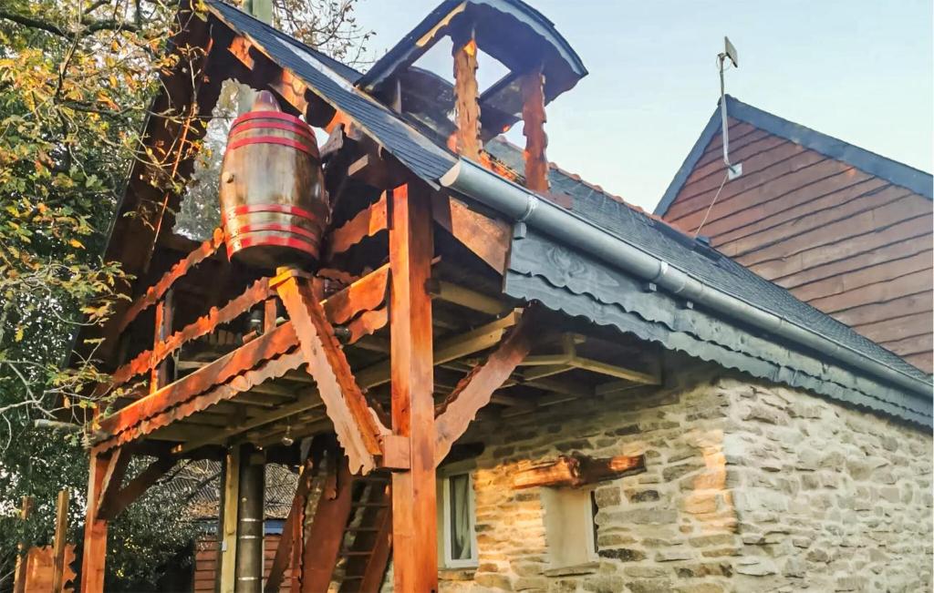a house with a large pipe on the side of it at La Tanière in Rosporden