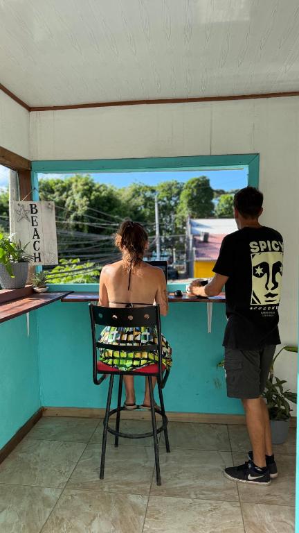 a man and a woman standing at a counter at Soul Rebel Hostel in Puerto Viejo