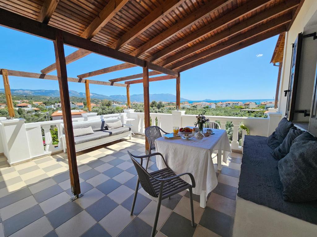 a room with a table and chairs on a balcony at Lemon Nest in Marathokampos