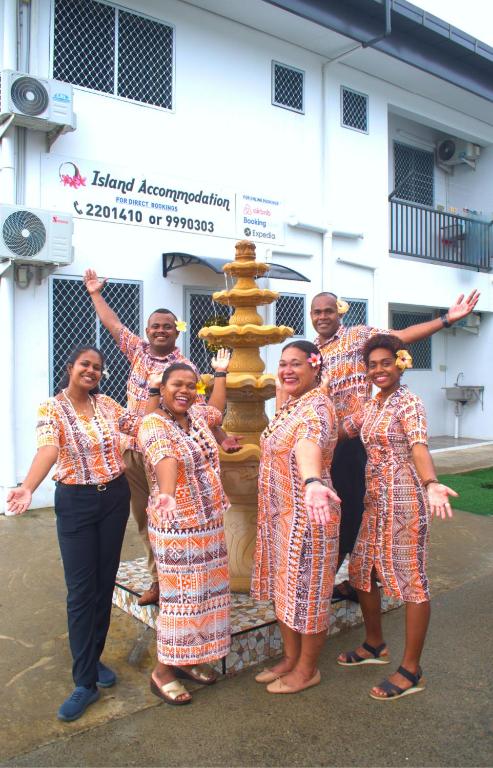 a group of women standing in front of a fountain at Island Accommodation Suva Premier Hospitality in Suva