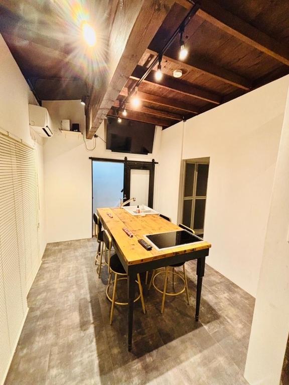 a kitchen with a wooden table and chairs in a room at Kamakura S house in Yokohama