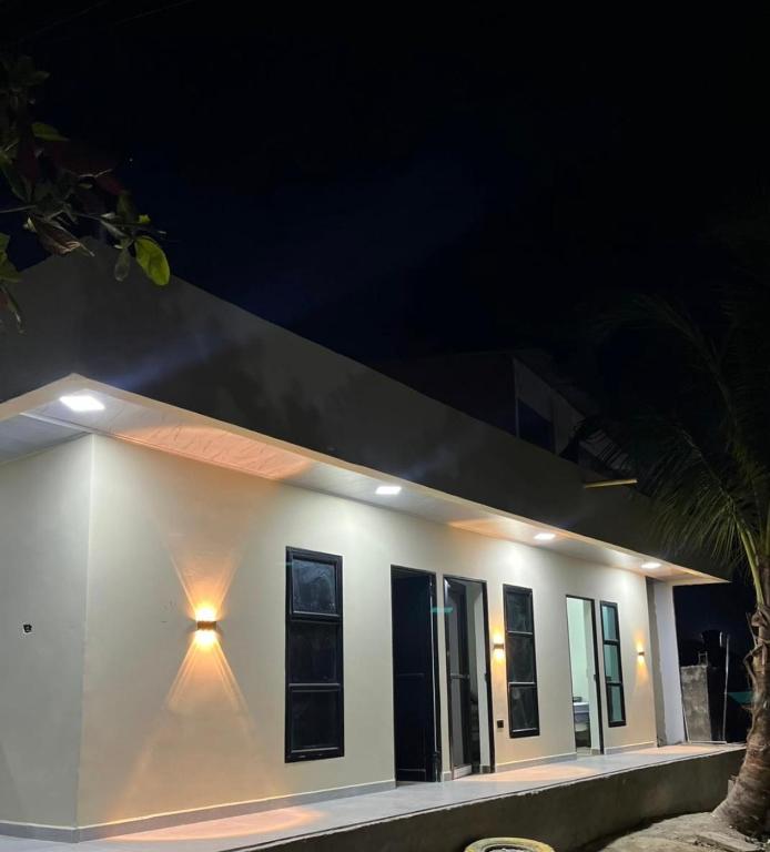 a white building with a light on it at night at Hotel ANY in Los Córdobas