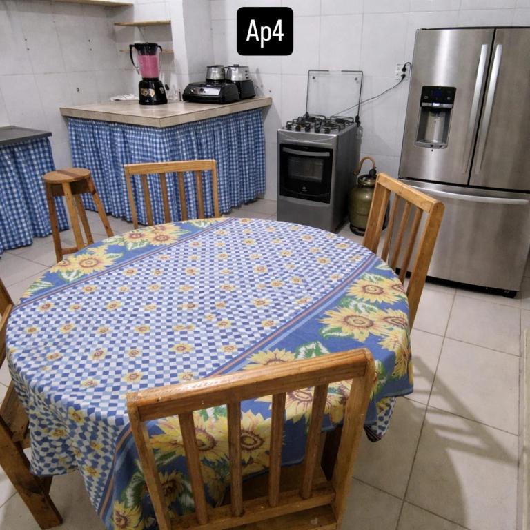 eine Küche mit einem Tisch, zwei Stühlen und einem Herd in der Unterkunft Residencial Romulo Casa in Manaus