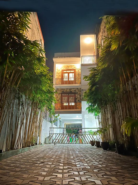 a building with palm trees in front of it at Blessora Sky Retreat in Kalutara