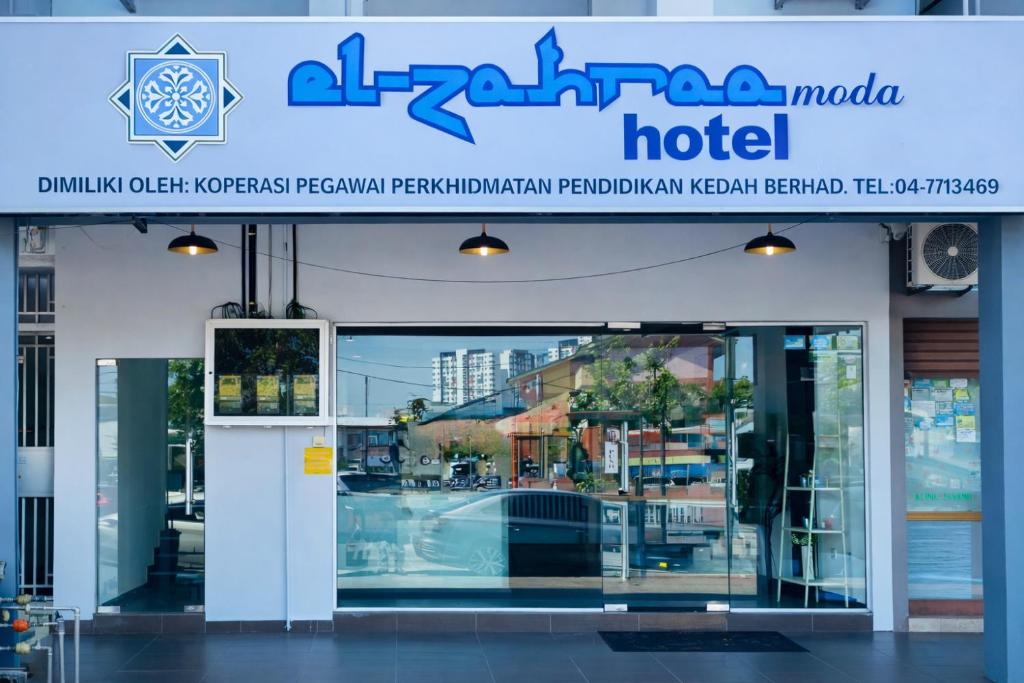 a hotel sign in front of a building at EL Zahraa Moda Hotel Alor Setar in Alor Setar