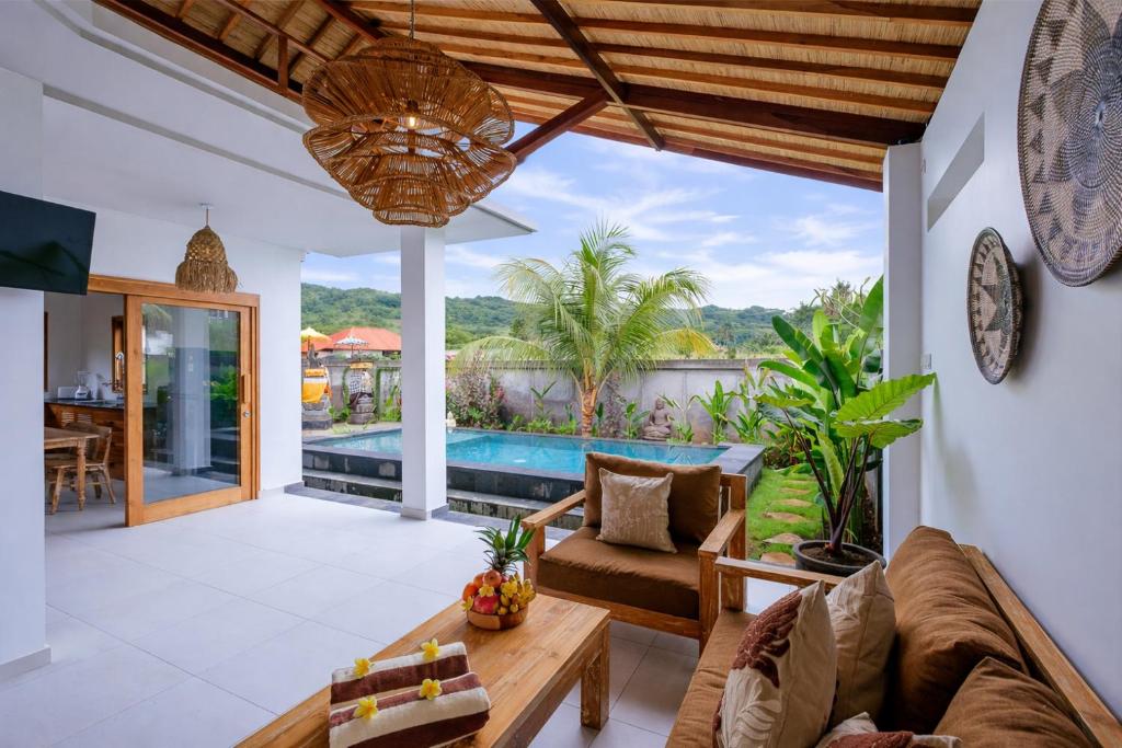 an open living room with a view of a pool at Villa Jati Private Pool - Amed in Amed
