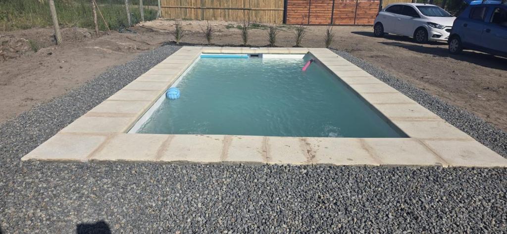 a small pool of water in a gravel driveway at Tres de Mayo in San Luis