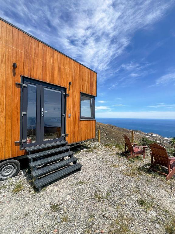 a wooden house on top of a hill at De la Luz Ecolodge by Tiny Away in Polopos