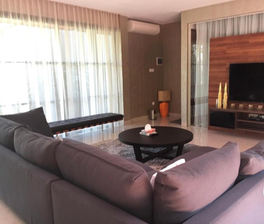 a living room with a couch and a table at Green Minimalist in Jakarta