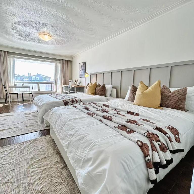 a large bedroom with two large beds in it at Cozy Studio with 2 Beds & Private Bathroom in Toronto