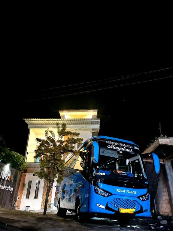 a blue bus parked in front of a building at Villa Kanaya in Sukapura