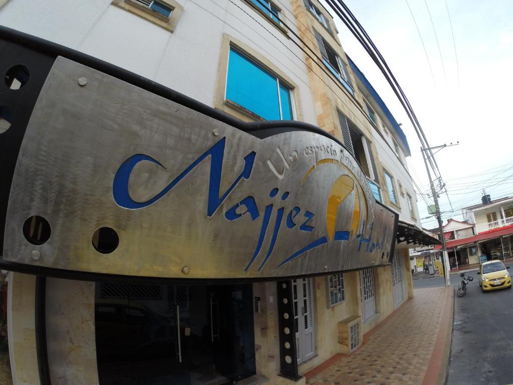 a sign on the side of a building at Hotel Najjez in Villavicencio