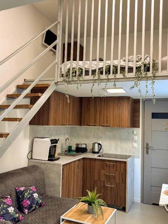 a living room with a kitchen and a staircase at Szarów 414 in Szarów