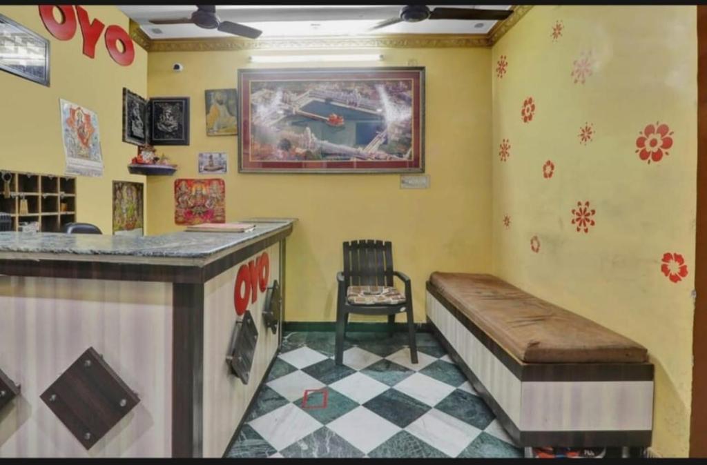 a restaurant with a counter and a chair in a room at RROOMS Eco Hotel Best in Lucknow