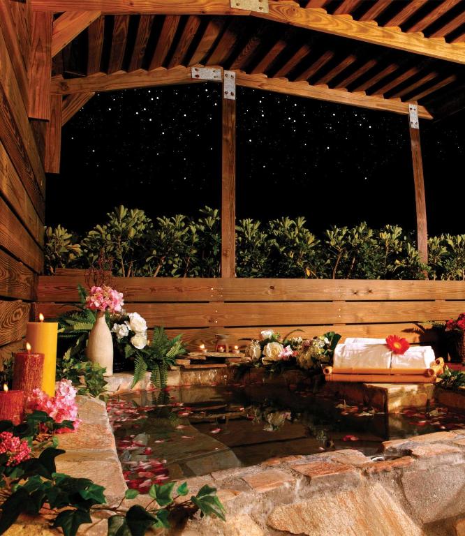 a pavilion with a bench and flowers in a garden at Formosan Naruwan Hotel in Taitung City