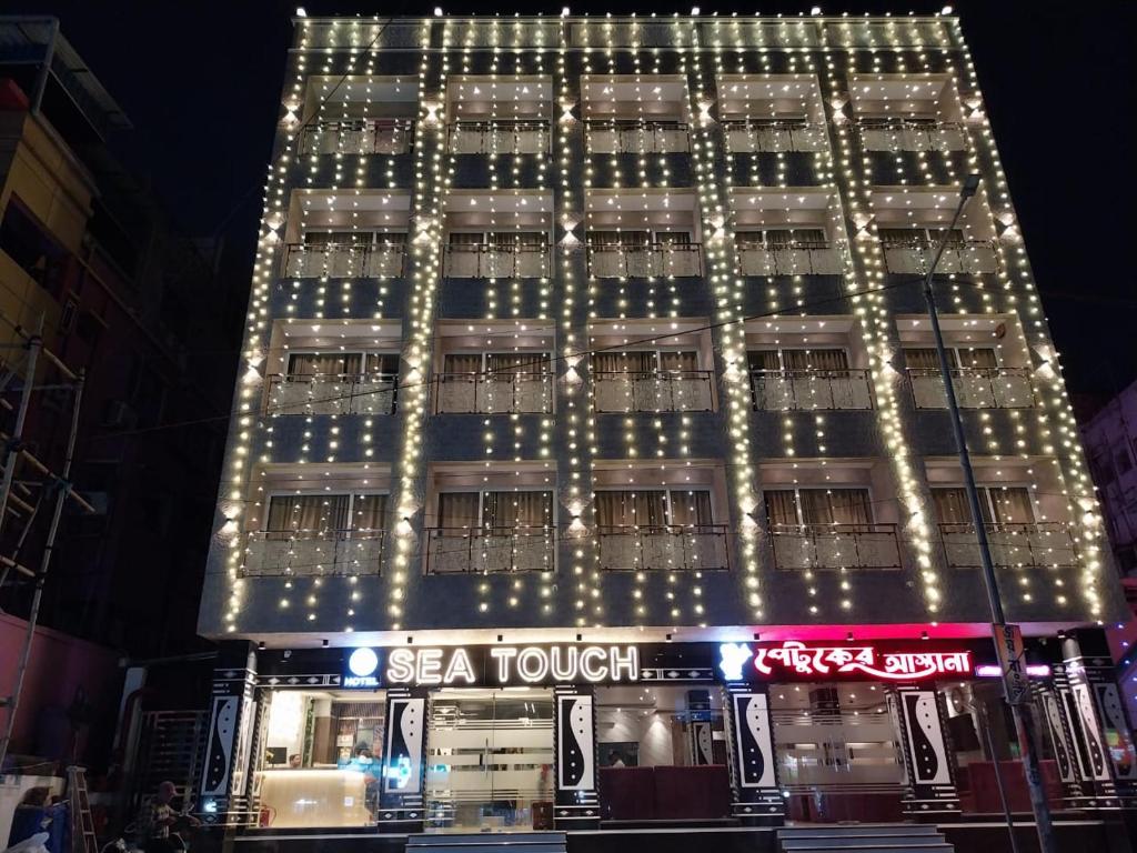 a tall building with lights on top of it at Hotel Sea Touch in Digha