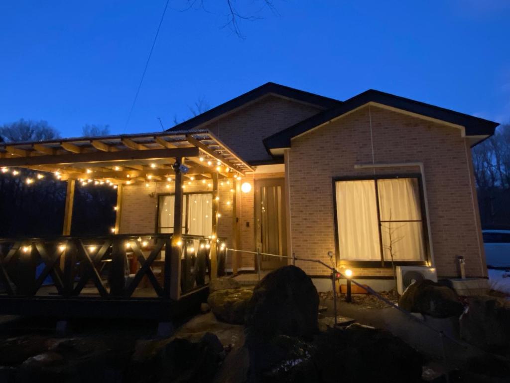 a house with christmas lights on the front of it at コテージオギー in Nasu