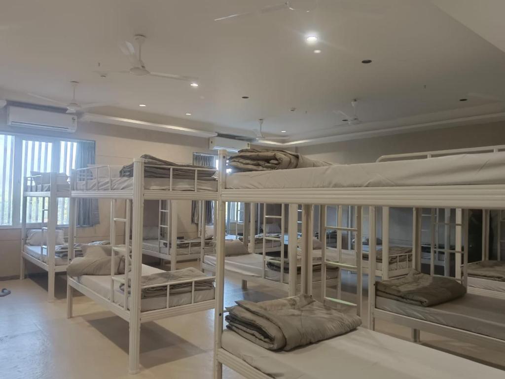 a group of bunk beds in a room at Sarju Palace Dormetry in Valsād