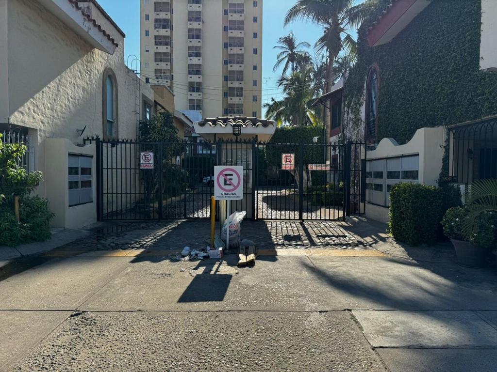 a no parking sign in front of a gate at Not for rent in Mazatlán