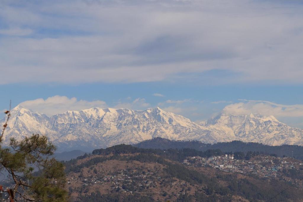 a view of a mountain range with snow covered mountains at The Trishul Vista in Mukteshwar