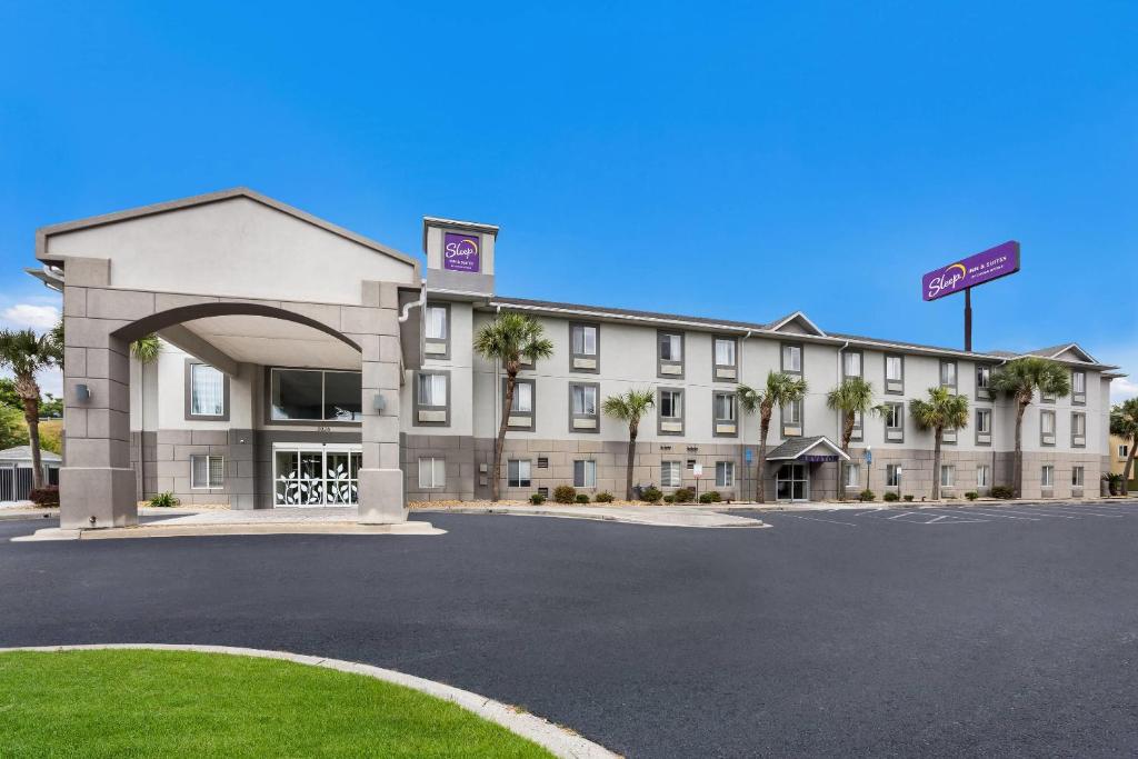 a hotel with a parking lot in front of it at Sleep Inn & Suites Valdosta Mall Area in Valdosta