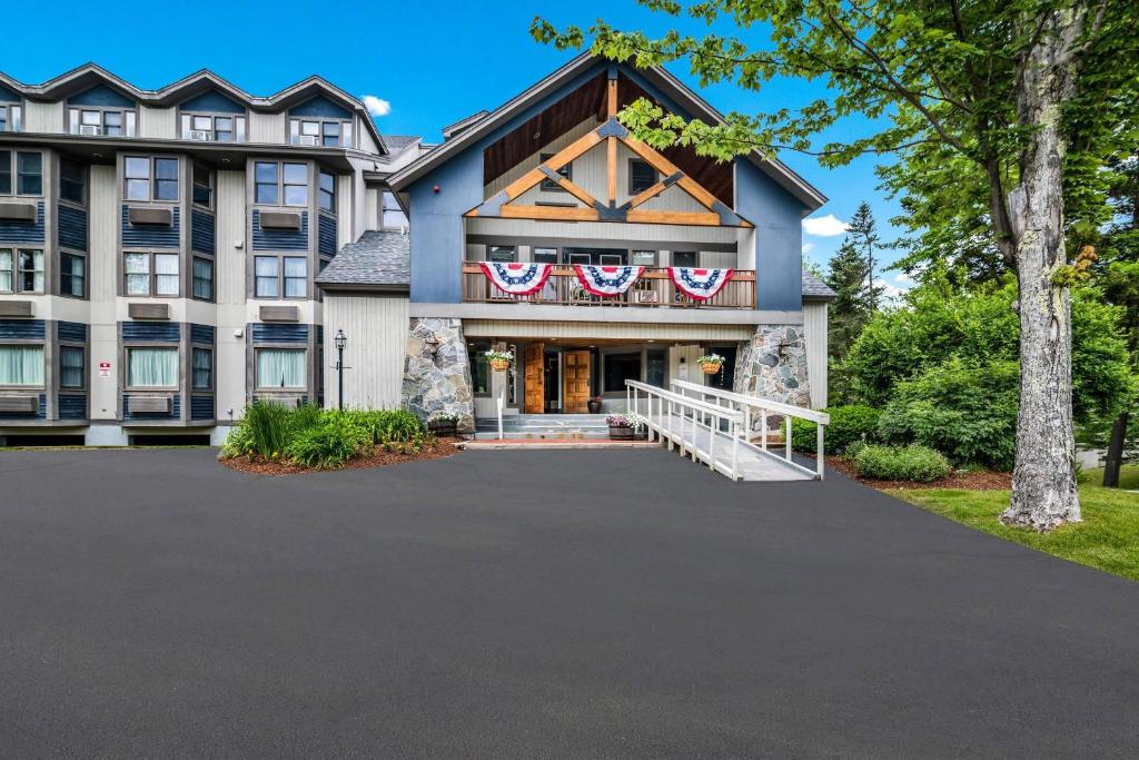 a house with american flags on the front of it at The Valley Inn, an Ascend Collection Hotel in Waterville Valley