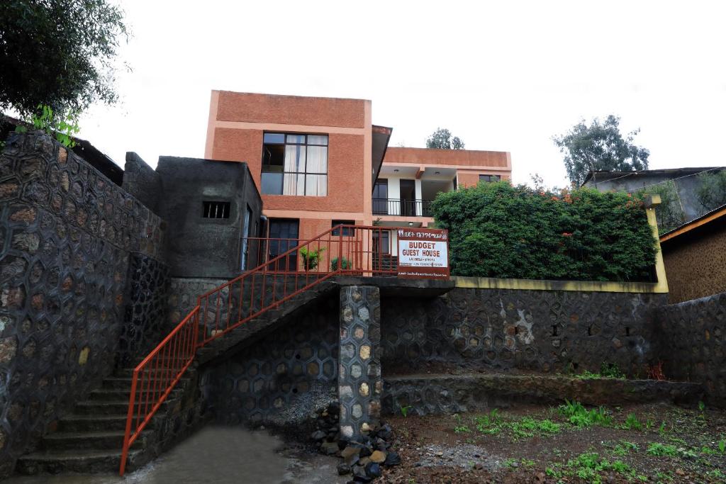 a building with a staircase in front of a building at Budget Gest House in Lalibela