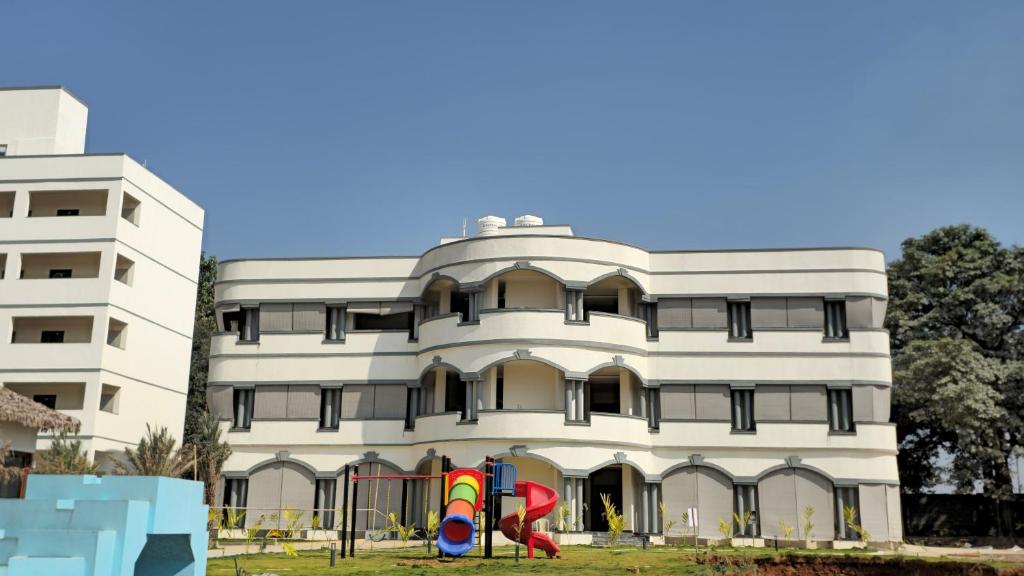 a building with two colorful kites in front of it at Stellar 23 Resort in Whitefield