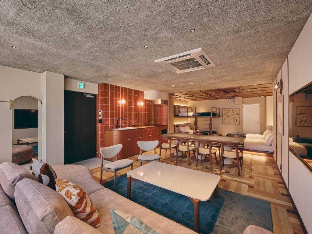 a living room with a couch and a table at illi Nuto Shinjuku in Tokyo