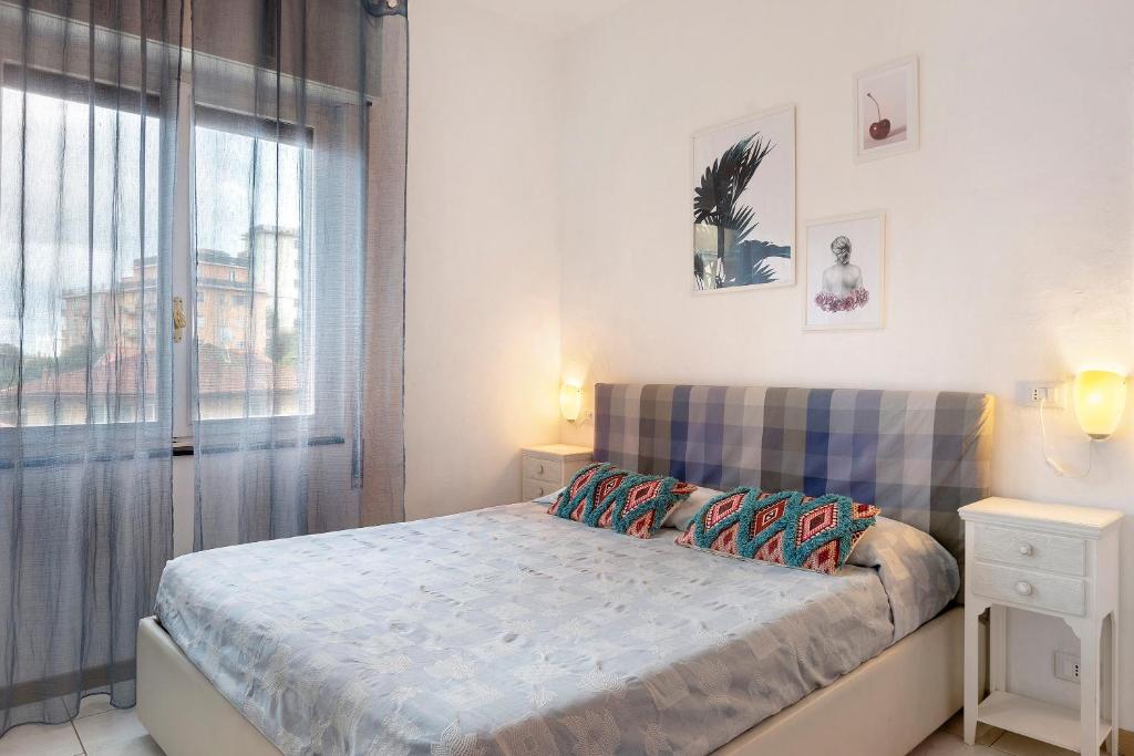 a bedroom with a bed and a large window at Albachiara in Rapallo