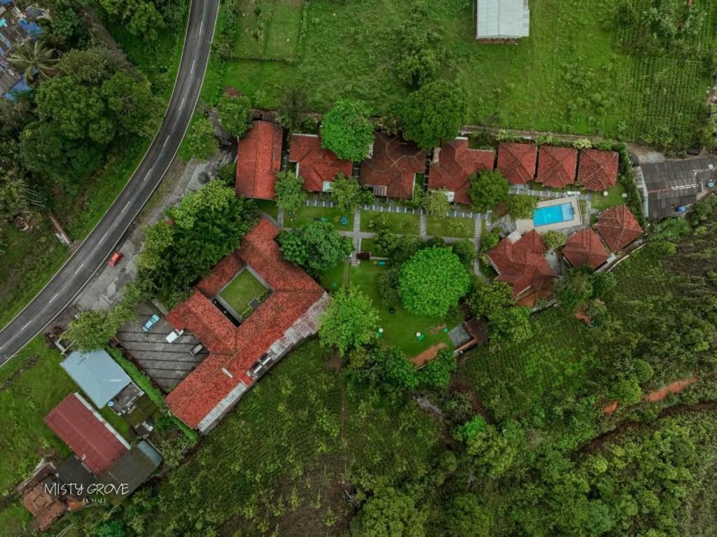 an overhead view of a house with trees and a road at Misty Grove Resort in Devāla