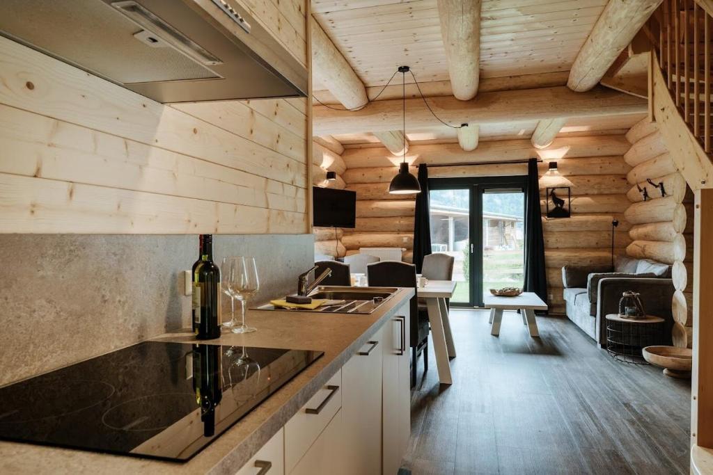 a kitchen in a log cabin with a counter top at Luxury Chalet near Ski Slopes in Jenig