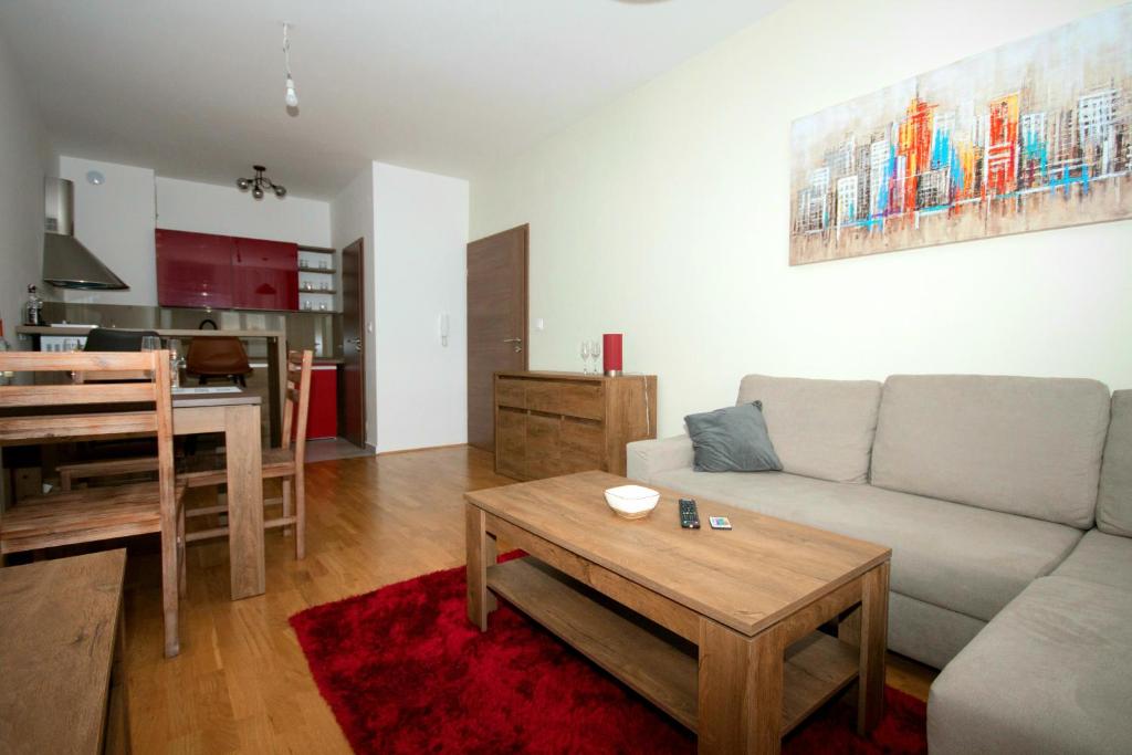 a living room with a couch and a table at Apartment Butterfly in Osijek