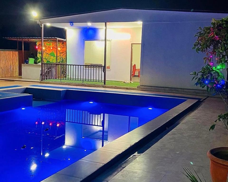 a swimming pool with blue lighting in a house at Drop Hills Farm Noida in Noida