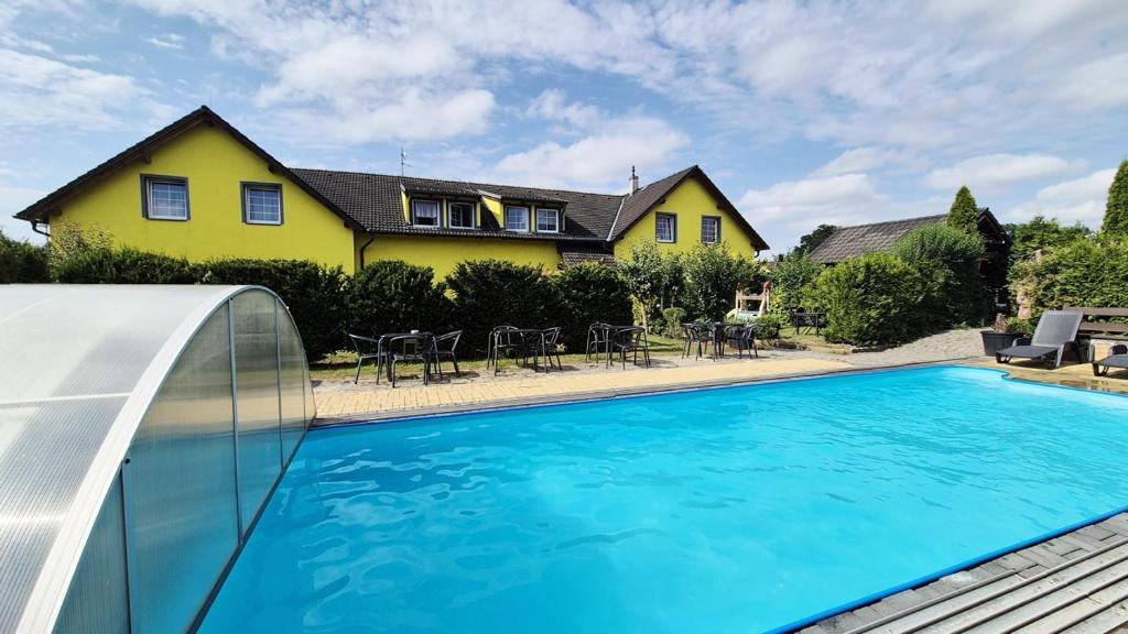 a house with a swimming pool in front of a house at Ubytování U draka in Třeboň