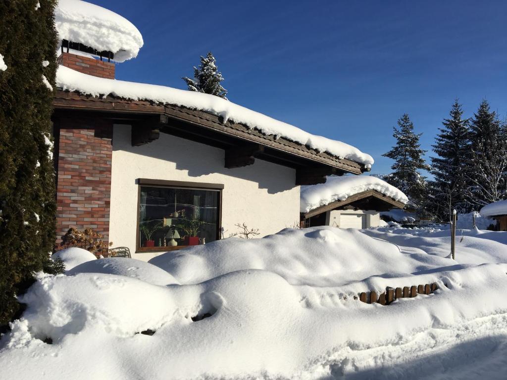 a house covered in snow in front at Bungalow Nr. 33 in Altenmarkt im Pongau