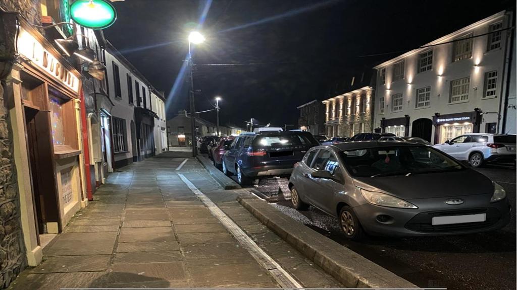 a street at night with cars parked on the street at Blacklion Holiday Homes in Blacklion