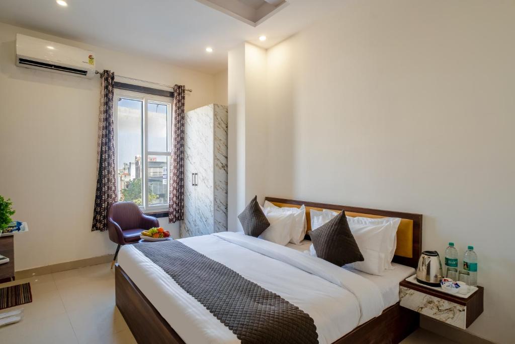a bedroom with a large bed and a window at Hotel Delhi 53 Near ISBT Kashmiri Gate in Delhi