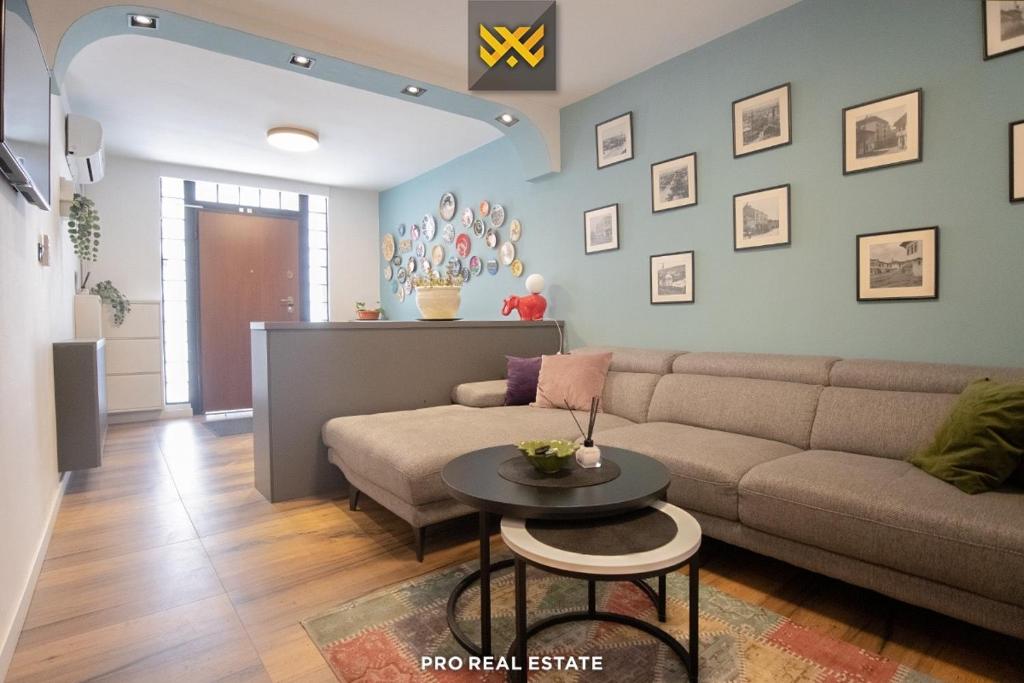 a living room with a couch and a table at Home City Center - 3BedR & 3BathR - Free Private Parking in Prishtinë