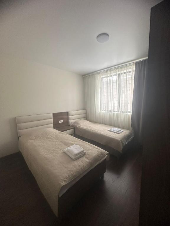 a room with two beds and a window at Mini hotel falcon in Bakuriani