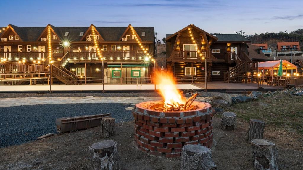a brick fire pit in front of a lodge at Daecheon Ocean Forest Pension in Boryeong