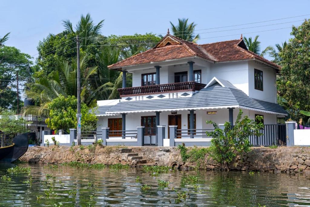a house on the banks of the river at Backwater Home in Kumarakom