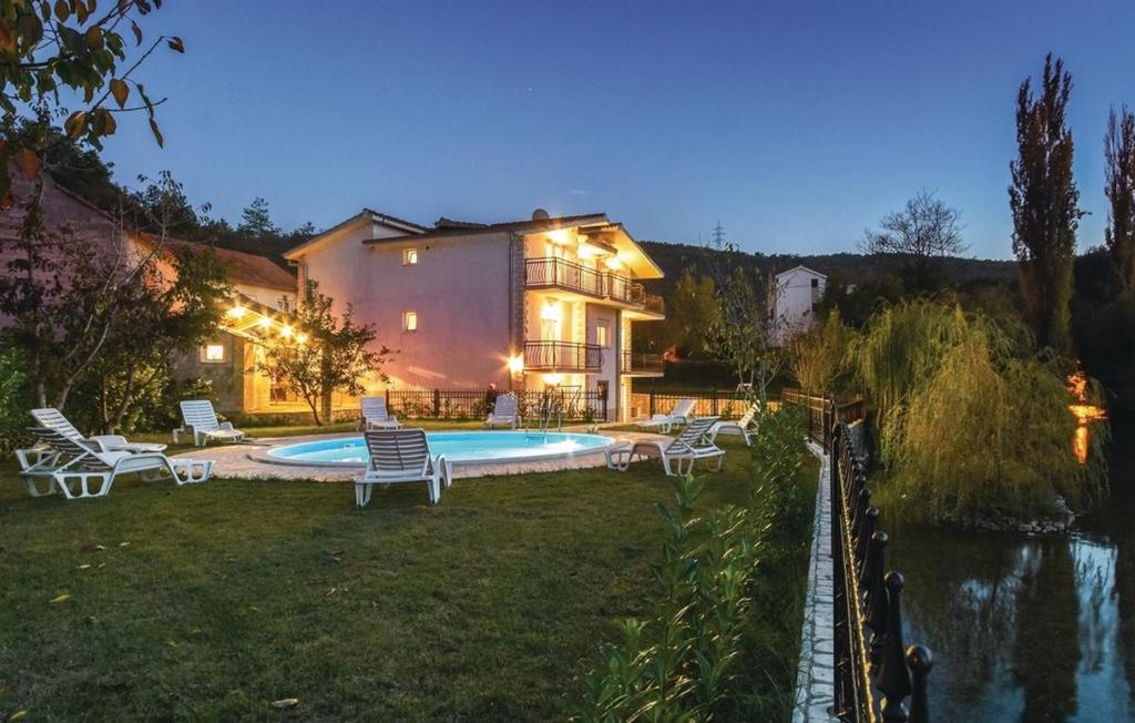 a house with a swimming pool in the yard at Villa Cascata in Trilj