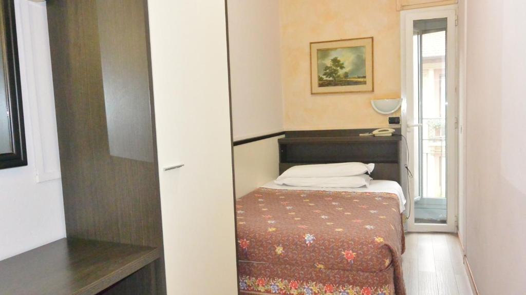 Postel nebo postele na pokoji v ubytování Hotel Arno