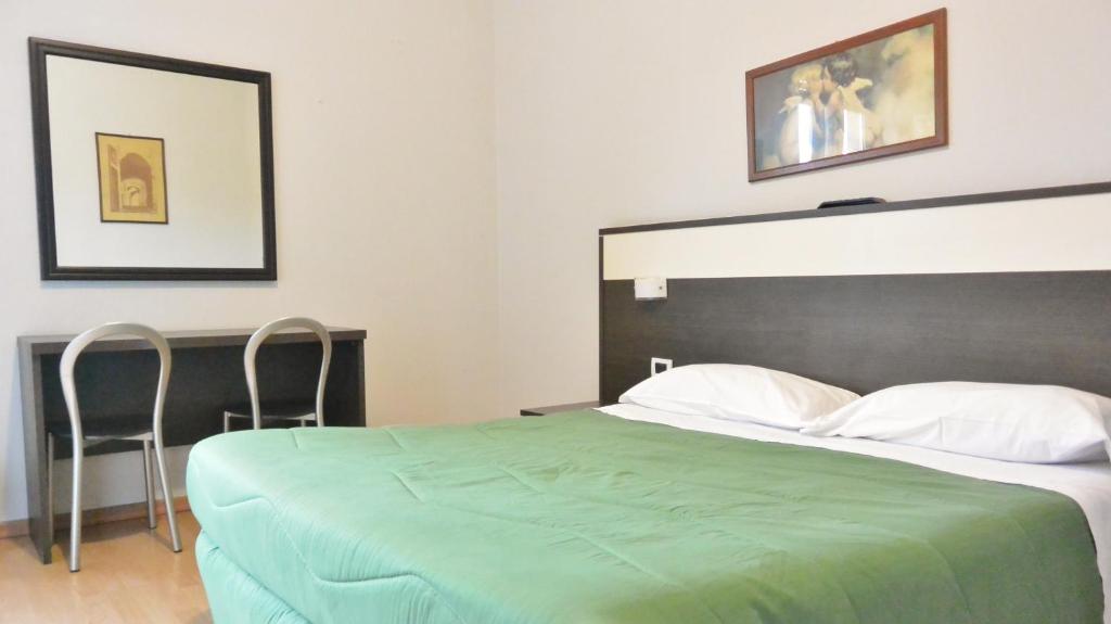 Postel nebo postele na pokoji v ubytování Hotel Arno