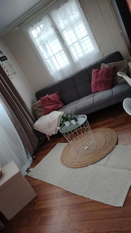 a living room with a couch and a table at Camping le petit RIO in Noyelles-sur-Mer